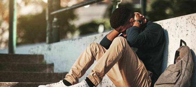 Young man, stressed and tired on university or college campus