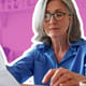 Senior mature business woman holding paper bill using calculator.