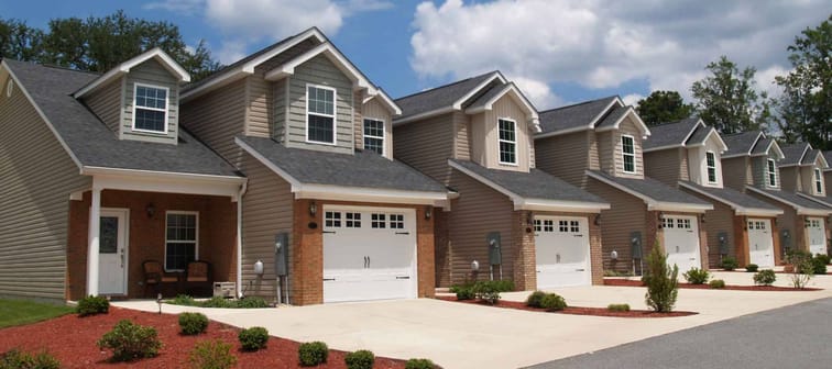 Two story low income retirement homes with the garage in the front.