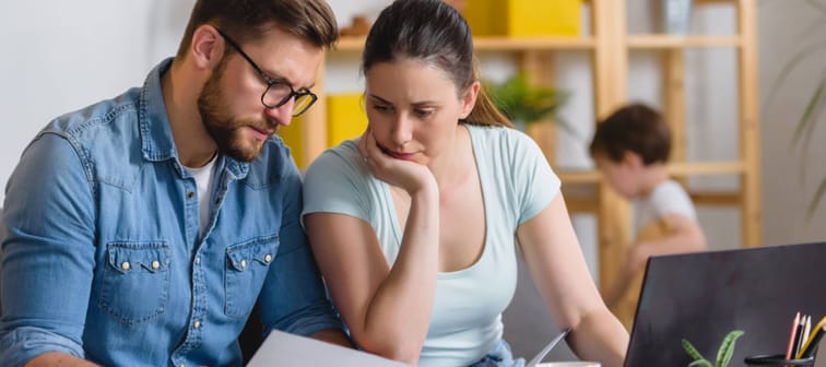 Family with a child having financial problems, doing home budgeting, calculating expenses.
