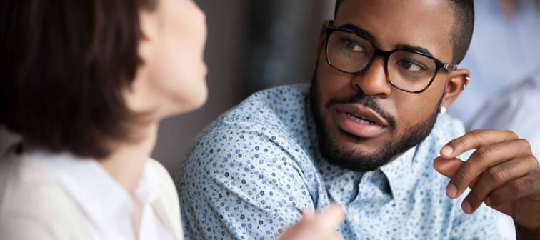 Close up of colleagues discussing something in office