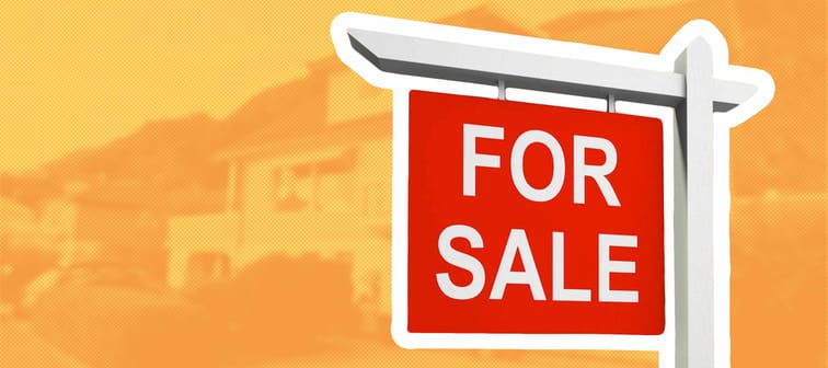 Real estate sign in front of new house for sale