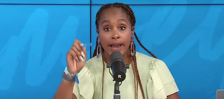 Jade Warshaw speaks directly to camera while on set of the Ramsey Show.