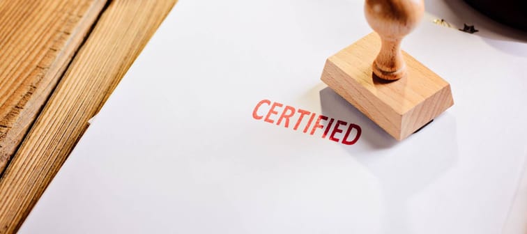 Red certified rubber stamp on white sheet of paper. Law office.