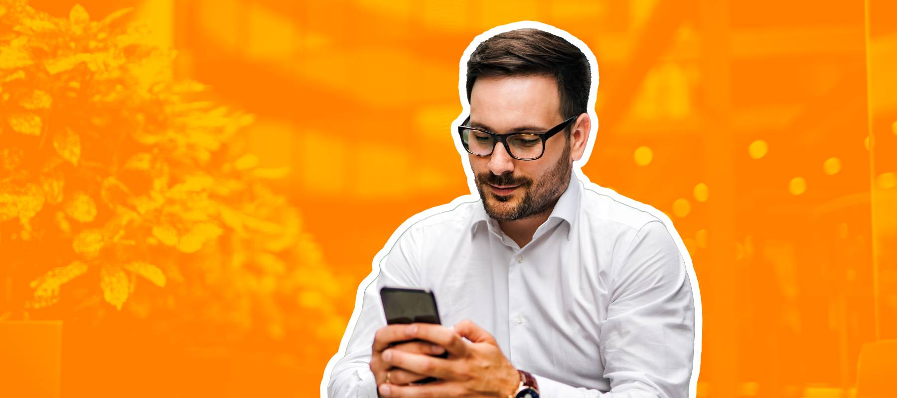 Businessman siting in front of a building on his phone